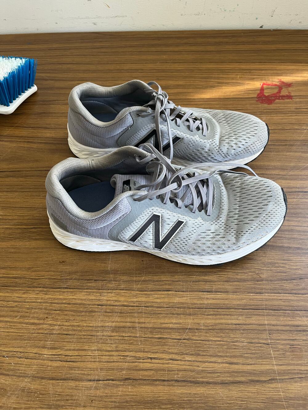New Balance grey mesh lace-up running sneakers with black logo and cushioned sol